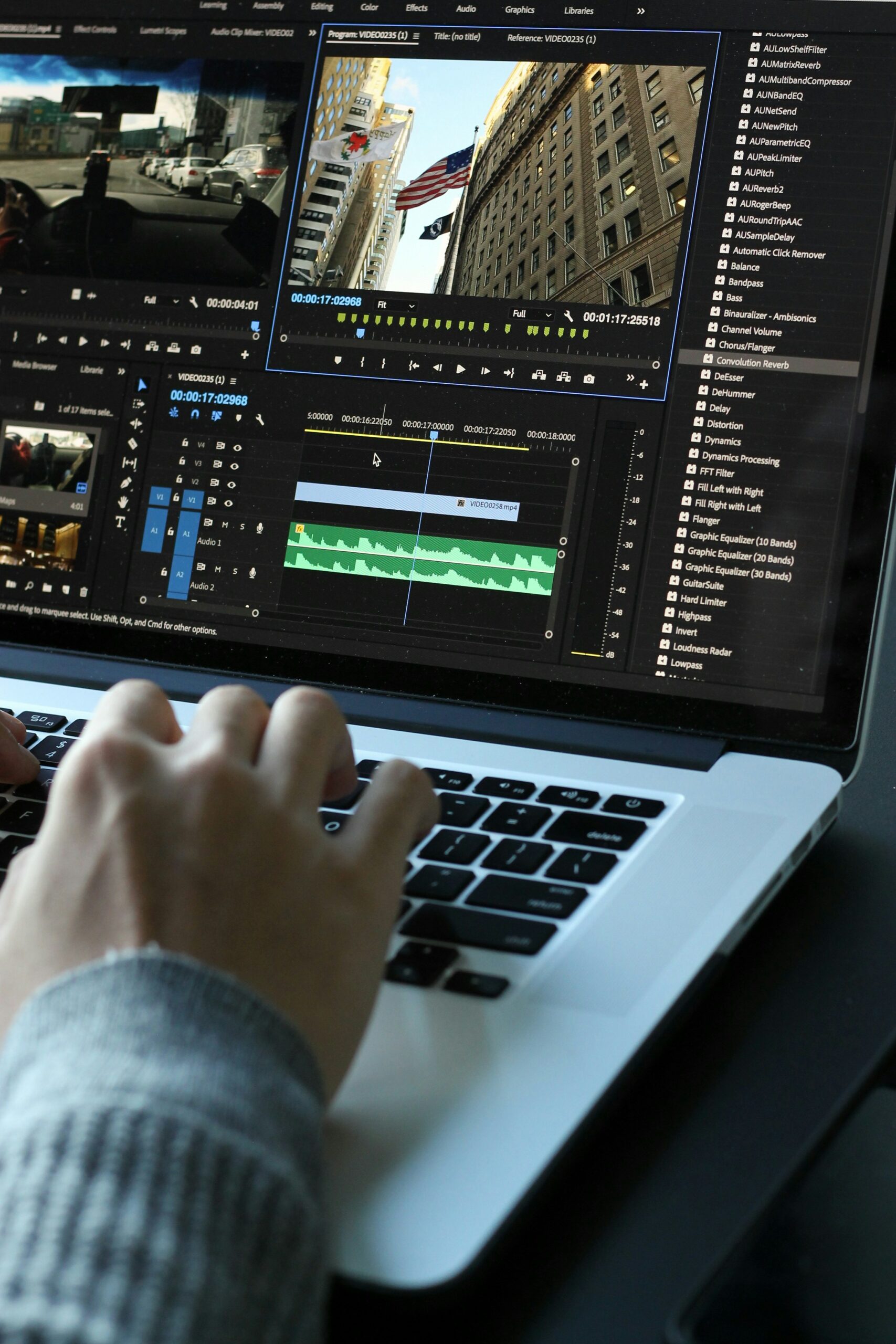 Someone working on a laptop, editing a video in Adobe Premiere Pro.